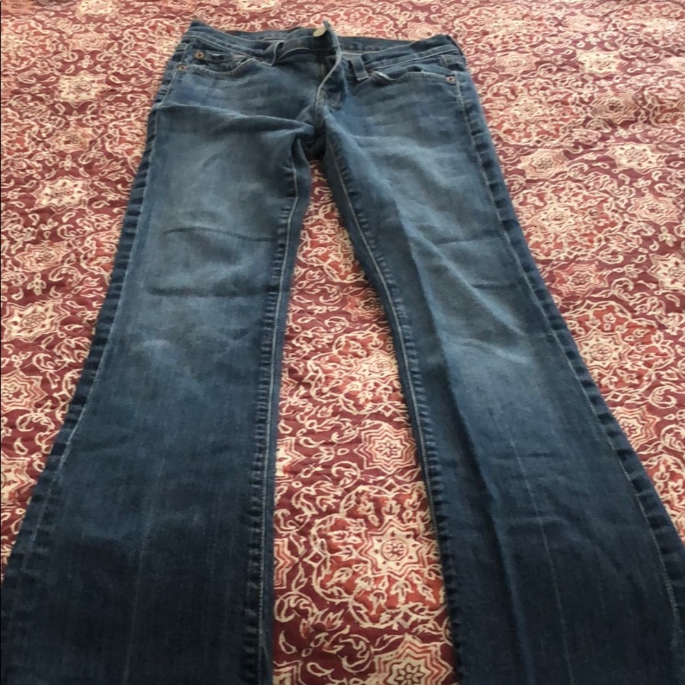 7 For All Man Kind medium blue boot cut jeans.